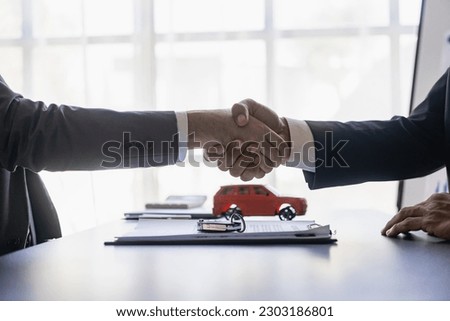 successful handshake and agreement Car dealers and customers celebrate contract completion after signing insurance and investment loans. car sale concept
