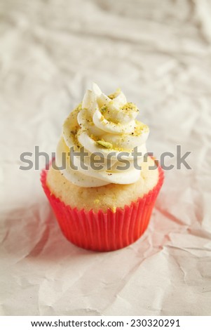 Vanilla cupcake with pistachio sprinkles with clear space