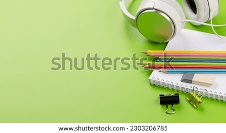 School supplies and stationery on green background. With blank space