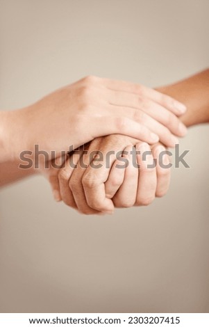 Empathy, support and prayer with people holding hands in comfort, care or to console each other. Trust, help or love with friends praying together during depression, anxiety or the pain of loss Royalty-Free Stock Photo #2303207415