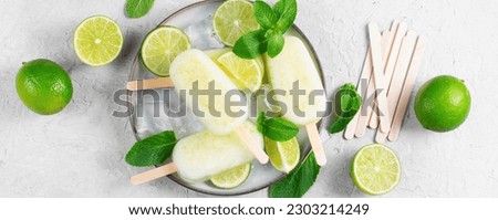 Refreshing Lime Popsicles, Brazilian Lemonade Ice Lolly with Fresh Lime and Mint on Bright Background, Healthy Dessert Royalty-Free Stock Photo #2303214249