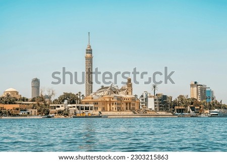 The Nile in Cairo, view on the TV Tower. A tower with a viewing platform in the center of Cairo, Egypt. View from the water of the Nile. Royalty-Free Stock Photo #2303215863