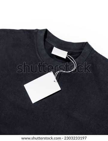 Black t-shirt with blank clothing price tag or label mockup. Ecology concept. Clothing sale concept Royalty-Free Stock Photo #2303233197