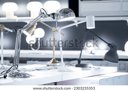 Difference modern desk lamp in lighting store or home furniture design shop.