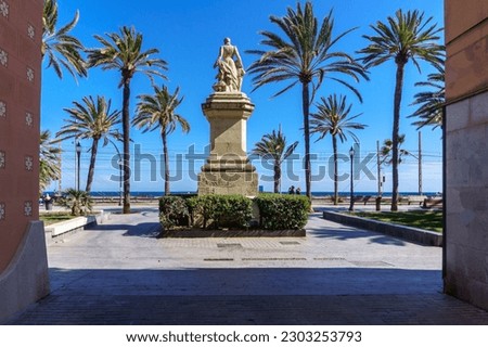 Ramblas , Badalona, Spain with modernist buildings and the statue of Roca i Pí. Seafront promenade Royalty-Free Stock Photo #2303253793