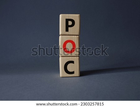 POC - Proof of Concept symbol. Wooden cubes with words POC. Beautiful grey background. Business and POC concept. Copy space.