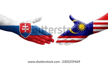 Handshake between Malaysia and Slovakia flags painted on hands, isolated transparent image.