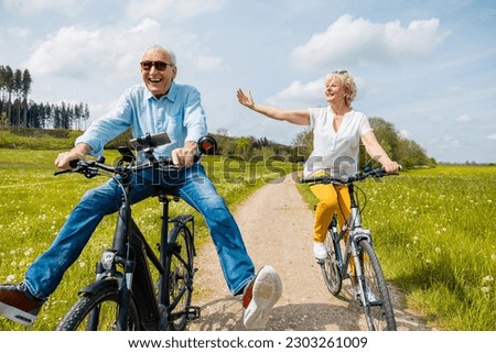 Seniors having fun on bicycles in spring
