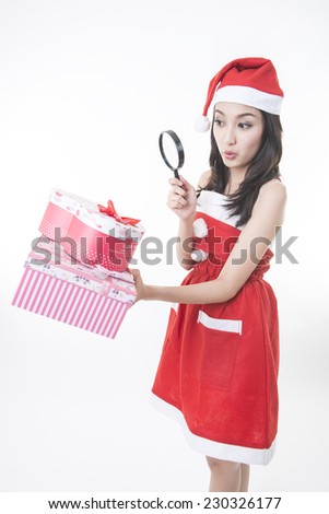 Christmas Santa hat isolated woman portrait hold christmas gift. Smiling happy girl on white background. 