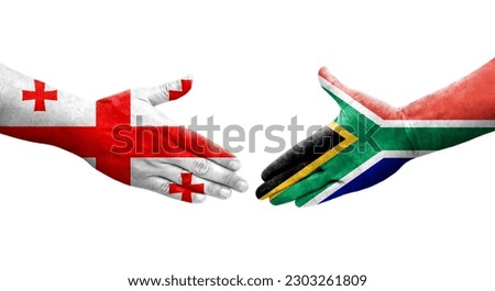 Handshake between South Africa and Georgia flags painted on hands, isolated transparent image.