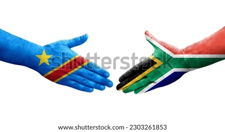 Handshake between South Africa and Dr Congo flags painted on hands, isolated transparent image.