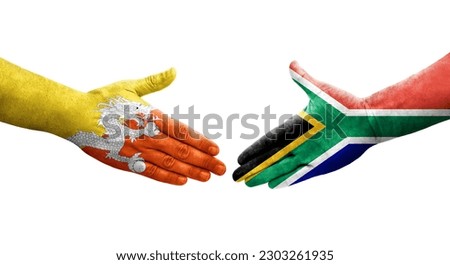 Handshake between South Africa and Bhutan flags painted on hands, isolated transparent image.