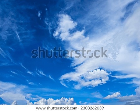 clear blue sky and white clouds in between