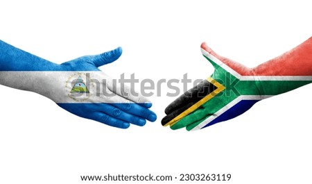 Handshake between South Africa and Nicaragua flags painted on hands, isolated transparent image.