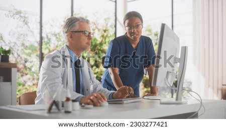 Multiethnic Health Care Medical Hospital. Professional African American Nurse and Doctor Having a Conversation, Using Computer, Discussing Patient Treatment, Drugs or Therapy