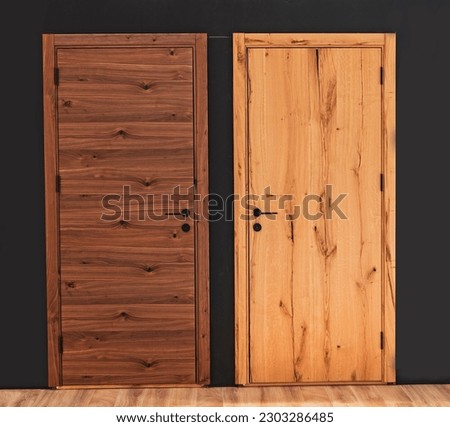 Dark and light closed wooden doors inside room entrances