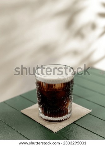 A cup of ice americano coffee Royalty-Free Stock Photo #2303295001