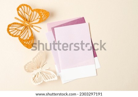 Blank reminder note and carve of paper butterfly on yellow background, space for text.