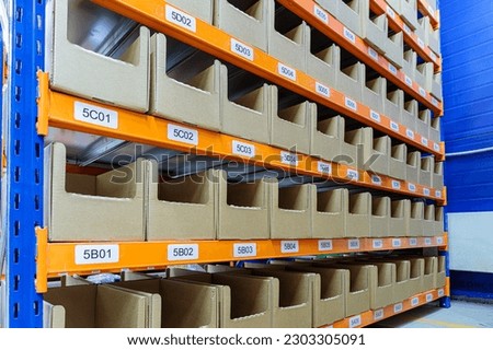 Boxes on racks in a warehouse of goods close-up. High quality photo