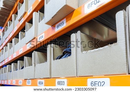 Boxes on racks in a warehouse of goods close-up. High quality photo