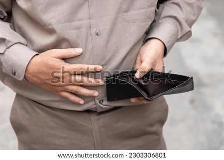 old senior man suffering from economic recession and lay off and having no money, concept of no money, great recession, joblessness, unemployment, financial problem, financial crisis  Royalty-Free Stock Photo #2303306801