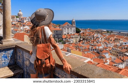 Woman tourist enjoying panoramic view of Lisbon city landscape- Portugal Royalty-Free Stock Photo #2303315841