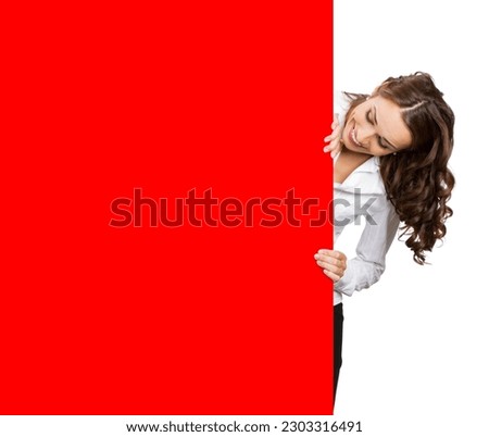 Business woman standing beehind, peeping out red empty signboard with blank copy space, isolated white background. Young businesswoman show, promote ad banner, advertise concept.