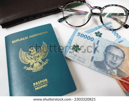 Green passport of the Republic of Indonesia, Indonesian rupiah isolated on white background 