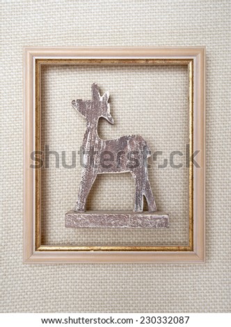 Christmas framed picture with reindeer on wool plaid  background  