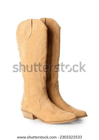 Suede cowboy boots isolated on white background Royalty-Free Stock Photo #2303323533