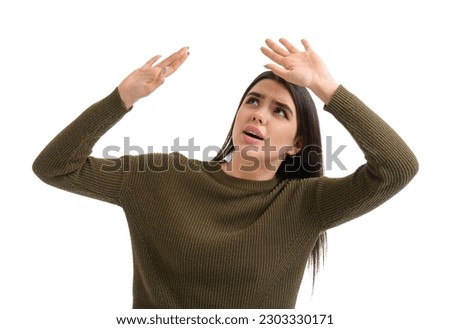 Scared young woman on white background Royalty-Free Stock Photo #2303330171