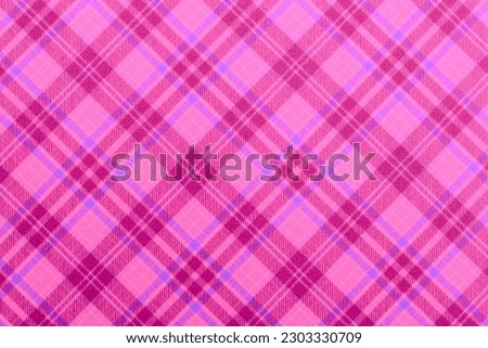 Christmas violet purple checkered background, texture seamless pink pattern fabric checkered, gingham backdrop. Plain classic Scottish plaid design. Suitable flannel pink textile. top view of table.
