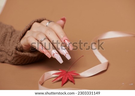 beautiful french manicure with chrysanthemum on white Royalty-Free Stock Photo #2303331149