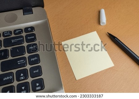 blank note with keyboard laptop and marker on wooden desk