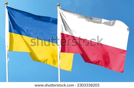 Flags of Poland flag and Ukraine flag. waving in the blue sky