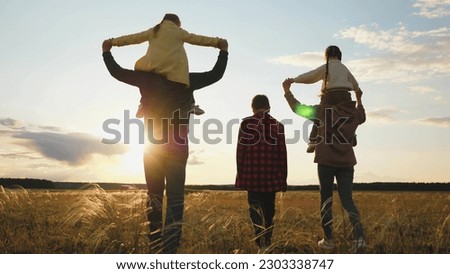 child mother father smile fun sunset. happy family sunny. chidhood dream. guardianship group team of people.parents boy girl. carry chid your shoulders., girl boy man woman running green grass, group
