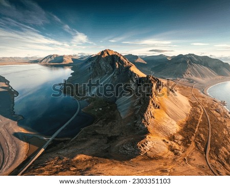 Aerial view of beautiful Mount Eystrahorn with Krossasnesfjall mountain range and sunlight shining on coastline in summer at East of Iceland Royalty-Free Stock Photo #2303351103