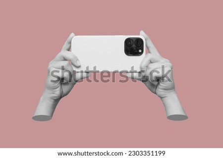Mobile phone with photo camera in female hands isolated on a pink background. Mockup of a smartphone. Young woman takes picture. 3d trendy collage in magazine style. Contemporary art. Modern design