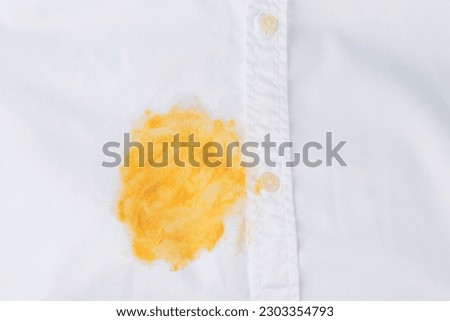Dirty yellow stain on a white shirt. Spoiled linen. isolated. top view. High quality photo Royalty-Free Stock Photo #2303354793