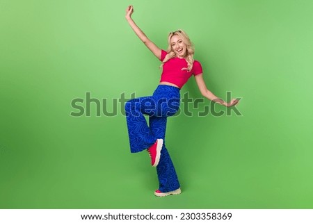 Full size portrait of gorgeous positive girl have fun dancing rejoice isolated on green color background Royalty-Free Stock Photo #2303358369