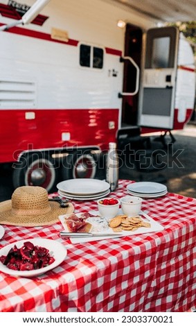 Charcuterie Board by a Red and White RV with Food - Outdoor Adventure