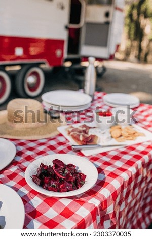 Beets on a Red and White Tablecloth by an RV at a Campground
