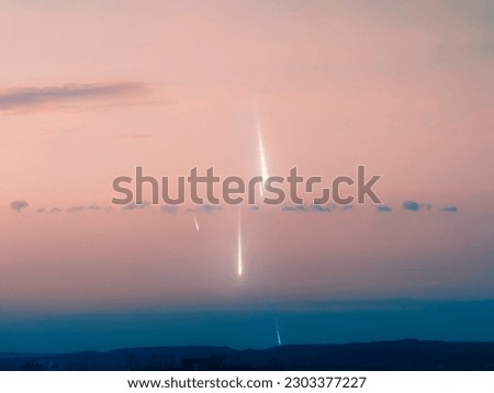 Meteors in the sky at sunset. Fall of meteorites in the light of the evening sun. Astrophotography of a meteor shower.