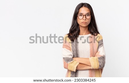 pretty thin hispanic woman feeling displeased and disappointed, looking serious