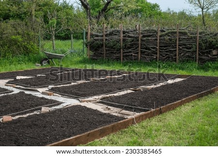 Create a new bed in the garden on a lawn, No Dig gardening method, Royalty-Free Stock Photo #2303385465