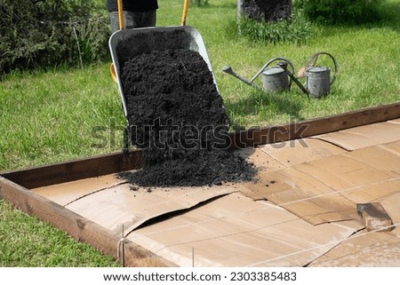 Create a new bed in the garden on a lawn, No Dig gardening method, Royalty-Free Stock Photo #2303385483