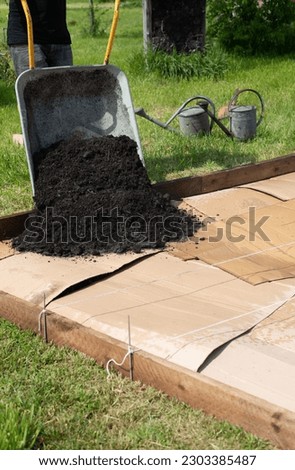 Create a new bed in the garden on a lawn, No Dig gardening method, Royalty-Free Stock Photo #2303385487