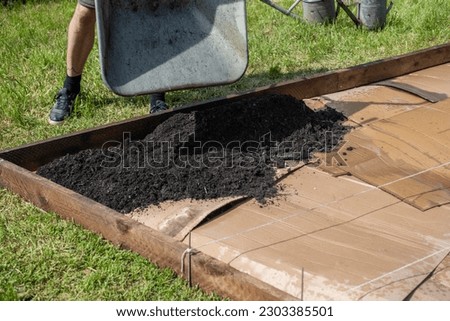 Create a new bed in the garden on a lawn, No Dig gardening method, Royalty-Free Stock Photo #2303385501