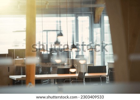 Light fixtures and desks in empty office Royalty-Free Stock Photo #2303409533
