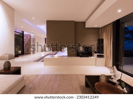 View of fireplace in luxurious living room during night Royalty-Free Stock Photo #2303412249